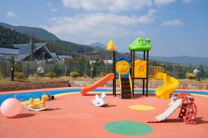 a childrens playground with a slide at Wyndham Lijiang Yulong in Lijiang