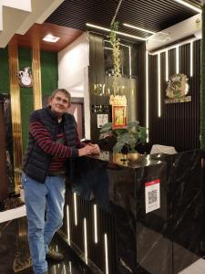a man standing next to a counter in a room at Hotel SK Residency in Varanasi