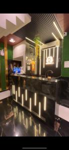a kitchen with a counter with lights on it at Hotel SK Residency in Varanasi