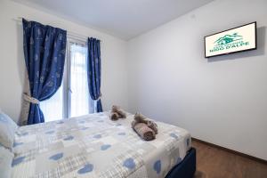 a bedroom with a bed with two teddy bears on it at CHALET GIOVANNI apricacasevacanze in Aprica