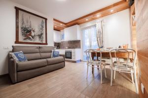 a living room with a couch and a table at CHALET GIOVANNI apricacasevacanze in Aprica