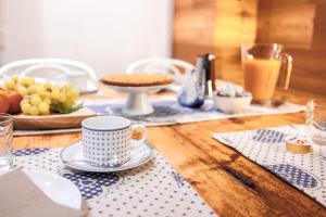 a wooden table with a cup of coffee on it at CHALET GIOVANNI apricacasevacanze in Aprica