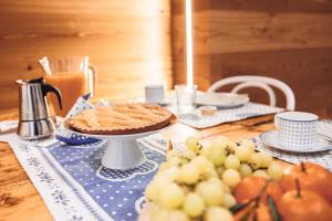a table with a pie on a table with fruit at CHALET GIOVANNI apricacasevacanze in Aprica