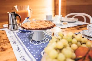 a table with a pie on a blue table cloth at CHALET GIOVANNI apricacasevacanze in Aprica +21 photos