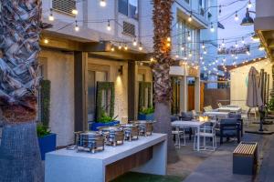 a restaurant with tables and chairs and lights at DoubleTree by Hilton Campbell - Pruneyard Plaza in Campbell