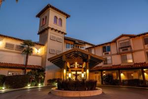 a building with a clock tower at night at DoubleTree by Hilton Campbell - Pruneyard Plaza in Campbell