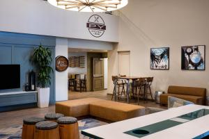a living room with a couch and a table at DoubleTree by Hilton Campbell - Pruneyard Plaza in Campbell