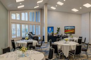 a conference room with tables and chairs and windows at DoubleTree by Hilton Campbell - Pruneyard Plaza in Campbell +79 photos