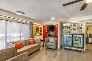 a living room with a couch and a refrigerator at Comfort Inn Hamilton - Stoney Creek in Hamilton