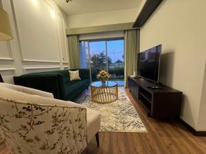 a living room with a couch and a television at The Golfside Luxe in Gonapola