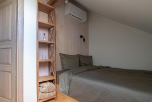a bedroom with a bed and a book shelf at Panekelpių vienkiemis in Aguriškės