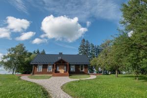 a house with a gravel path leading to it at Panekelpių vienkiemis in Aguriškės