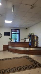 a lobby of a store with a cash register and a counter at Hotel i Camping Tramp in Toruń +35 photos