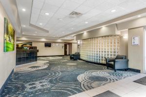a lobby with a waiting room with chairs and a television at Clarion Hotel & Suites in Brandon +33 photos