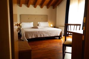 a bedroom with a bed with white sheets and a window at Sole della Franciacorta - Hotel & Restaurant in Capriolo