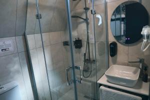 a bathroom with a shower with a toilet and a sink at Akcasehir Sosyal Tesisleri in Akçakoca +165 photos