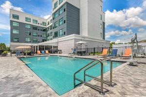 a swimming pool in front of a building at Cambria Hotel Tampa-Brandon in Tampa