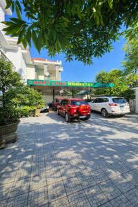 a parking lot with cars parked in front of a building at Nhat Long Homestay in Hue +51 photos