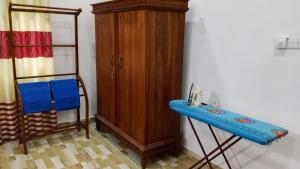 a wooden cabinet and a blue table in a room at Villa Rashel in Nikawatawana