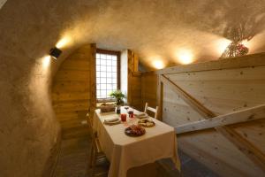 a dining room with a table and a barn door at Il Faita in Passo del Tonale