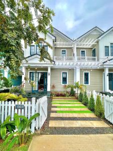 a white fence in front of a house at Sunset Villa - Novaworld Phan Thiết in Bình Tú +16 photos
