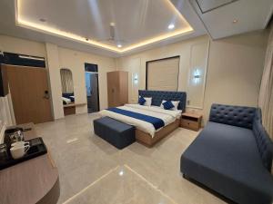 a bedroom with a bed and a couch and a chair at Hotel Shree Karni Palace in Kishangarh +13 photos