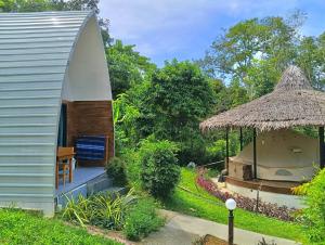 a small house with a thatch roof and aentedentedentedentedentedented at Castaway on Mook in Ko Mook