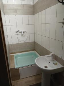 a bathroom with a bath tub and a sink at LIBERTY Hostel in Mykolaiv