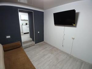 a living room with a flat screen tv on a wall at LIBERTY Hostel in Mykolaiv