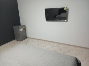 a room with a tv on the wall and a white floor at LIBERTY Hostel in Mykolaiv +7 photos