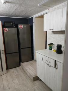 a kitchen with two refrigerators and a counter top at LIBERTY Hostel in Mykolaiv