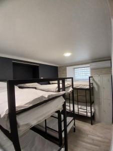 a room with three bunk beds and a window at LIBERTY Hostel in Mykolaiv