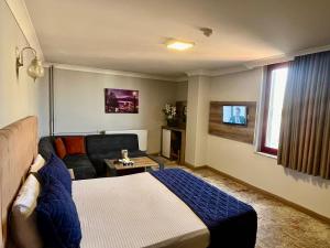 a living room with a bed and a couch at kocatepe hotel in Ankara