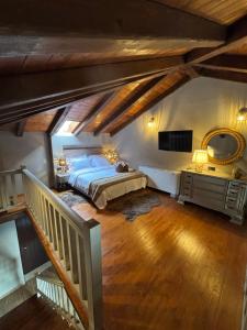 an attic bedroom with a bed and a mirror at Evita BelleVue in Arachova
