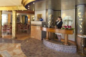 a man standing at a bar in a hotel lobby at Hotel Luis in Fiera di Primiero +107 photos