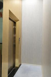 an elevator in a building with a glass door at Tam Ky XO Hotel in Tam Kỳ
