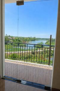 a room with a large window with a view of a river at Tam Ky XO Hotel in Tam Kỳ