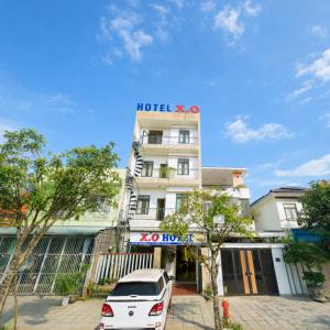 a white car parked in front of a building at Tam Ky XO Hotel in Tam Kỳ