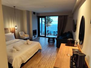 a hotel room with a bed and a large window at Evita BelleVue in Arachova