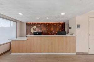 a lobby with a reception desk with a crescentresent at Comfort Inn & Suites Ormond Beach Oceanfront in Ormond Beach +45 photos