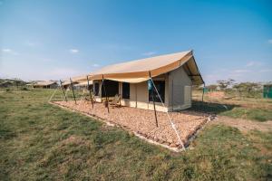 a tent in the middle of a field at Entepesi Tented Camp in Musiara Campsite