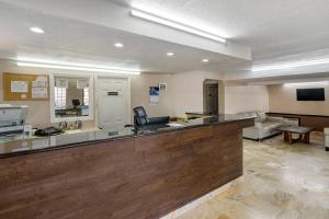 a large lobby with a bar with a couch at Rodeway Inn Clearwater-Dunedin in Clearwater