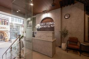 a lobby of a store with a clock on the wall at Quy Hung Hotel And Spa Central in Ho Chi Minh City