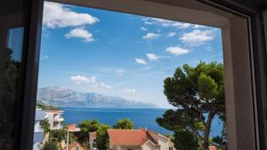 a view of a lake from a window at Villa Marina in Omiš