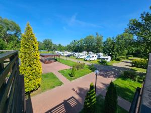 an aerial view of a parking lot with parked rvs at Hotel i Camping Tramp in Toruń