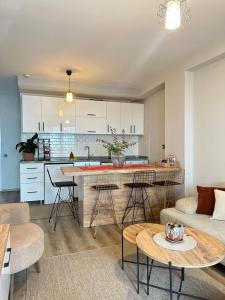 a kitchen and living room with a table and chairs at Lüks Konforlu ve merkezi ev in Çiftlikköy +13 photos