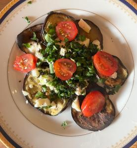 a plate of food with tomatoes and vegetables on it at Mas Redortier in Soyans