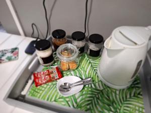a refrigerator shelf with spices and a utensil at Stay a While Self catering - Close to Greenacres Hospital, free Wi-Fi, and secure parking in Newton Park