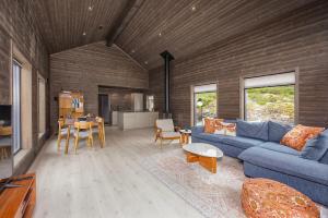 a living room with a blue couch and a table at Berre Veit 6p in Vradal