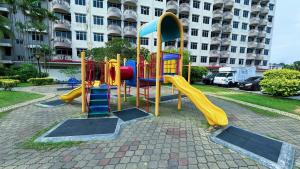 a playground with a slide in front of a building at Beachfront Bliss Sea View Glory Beach PD Homestay in Port Dickson